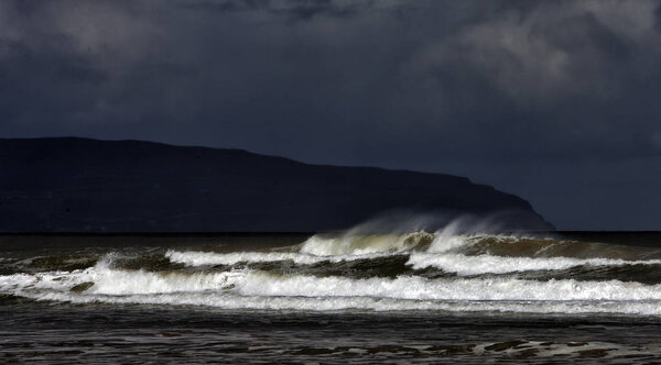 Layers of an incoming tide and storm on the Downhill Beach in th Stock Image