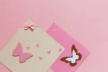 Butterfliy figyrines on the pink paper background clipart
