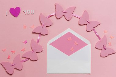 Pink butterflies garland and  pink envelope on the pink paper clipart