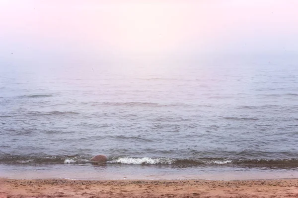 Quiet  foggy sunrise over the Baltic Sea in Latvia. Morning silence, calm on the sea. Natural background. Copy space for your text