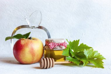 Apples and honey. Concept for Rosh Hashanah the Jewish New Year. Top view, close up on white background.