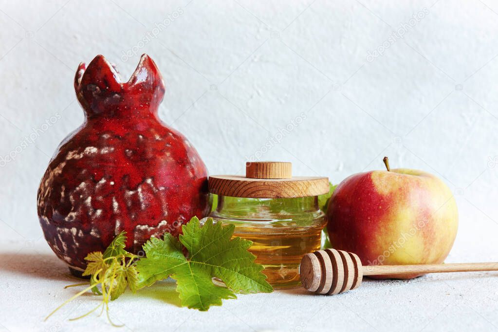 Apples and honey. Concept for Rosh Hashanah the Jewish New Year. Top view, close up on white background.