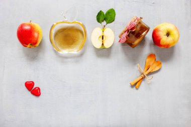 Apples and honey. Concept for Rosh Hashanah the Jewish New Year. Top view, close up on light gray background.	