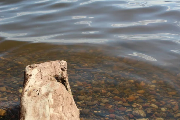 multi-colored stones in clear water /Photo of colored stones in the water.The water is clear, clearly visible bottom of the reservoir in the afternoon in the summer season.It\'s very beautiful.