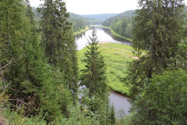 beautiful Ural landscape river and mountain View / beautiful landscape in the Perm region where the Usva river flows.Along the riverbank mountains, forests, glades.Water with fast current.The Ural river is very picturesque.Photo of Russian nature.