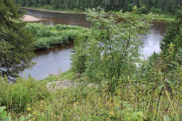 beautiful Ural landscape river and mountain View / beautiful landscape in the Perm region where the Usva river flows.Along the riverbank mountains, forests, glades.Water with fast current.The Ural river is very picturesque.Photo of Russian nature.