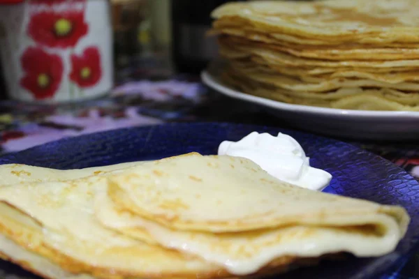 Krep ekşi ile tabağa krem / pişmiş krep fotoğraf. plaka üzerinde üç krep ve beyaz ekşi cream.pancakes yüksek kalorili ve tasty.good tatlı Kahvaltı, öğle yemeği ya da dinner.many krep geleneksel tatil o için Rusya'da pişmiş olan