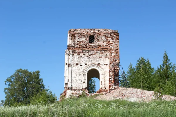 photo of the ruins of the ancient Church of Russia / the ruins of a historic building.the Church is old against the blue sky.architecture in the countryside.the walls of the building are destroyed by time.remained brick the wall,some with whitewash.t