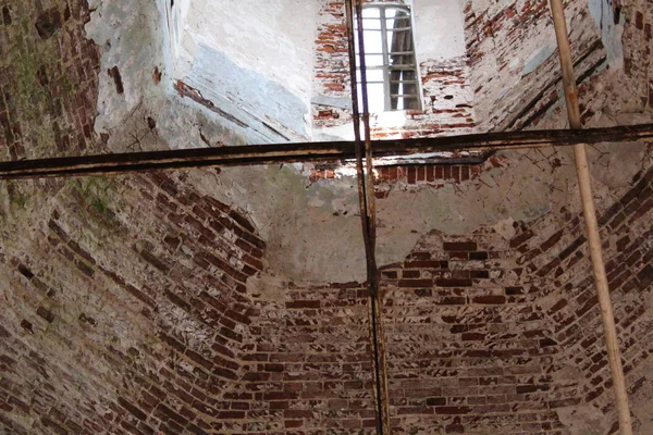 walls and Windows in the ruins of an ancient Church in Russia / photo of an ancient Church.of the temple there were walls.they were built of brick and whitewashed.the building has preserved Windows.the hole in the form of an arch.there are metal gril