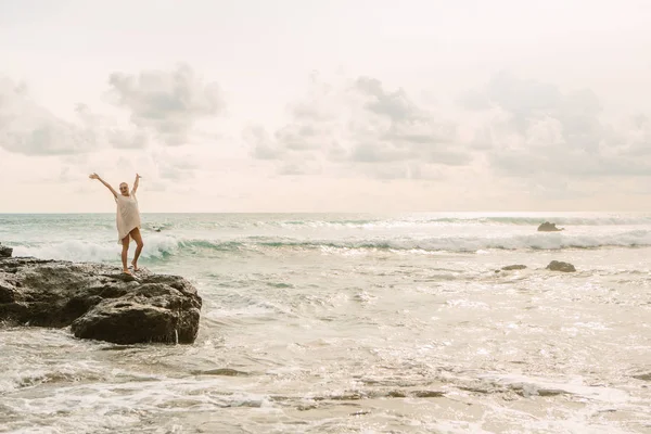 Chica Bonita Sonrisa Cámara Mientras Permaneces Piedra Frente Grandes Olas —  Fotos de Stock