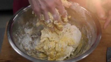 The process of manually baking dough. Women's hands are cooking