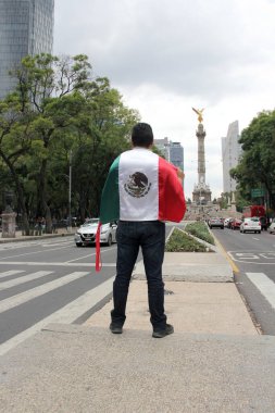 Mexico City, Meksika - 23 Ağustos 2023 İnsanoğlu ulusal bayramları kutlamak için Bağımsızlık Meleği 'nin önünde gururla Meksika bayrağını kaldırır.