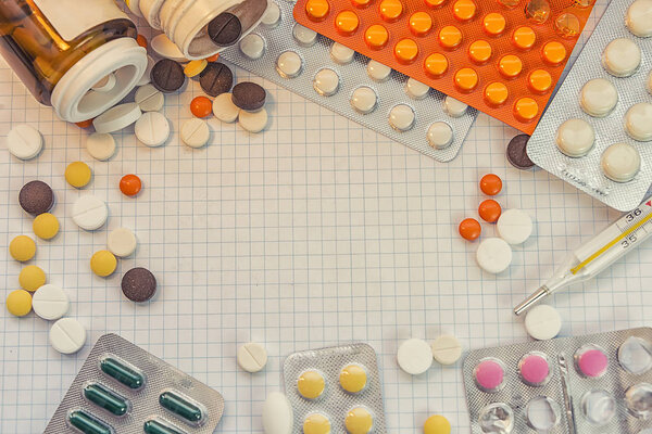 medicines are scattered on a sheet of paper, tablets in packages, means for stress, for weight loss and for various diseases, the effect of placebo