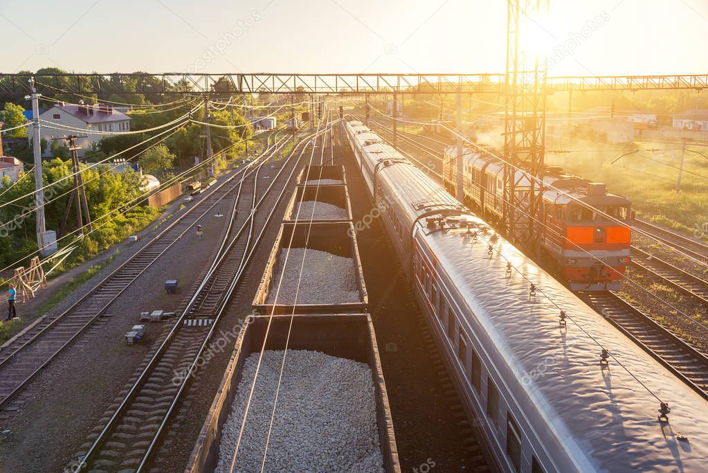 railroad cars at sunset, view from the top, with a reflection of the evening sun