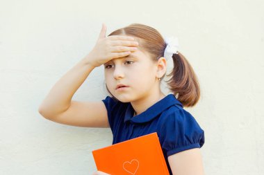 kız çocuk duvar arka plan üzerinde ders kitapları ile okul için hazırlanıyor