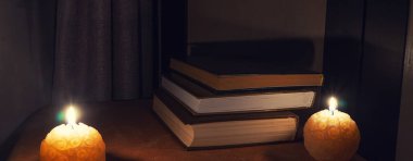 Masa üzerinde kitap gece ışıkları ve mumlar ile yaktı