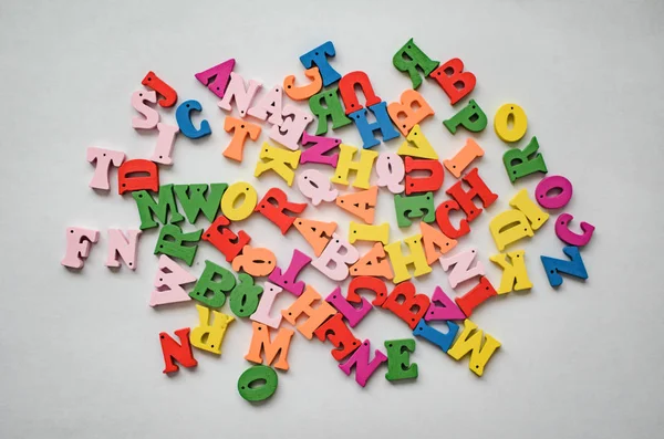 Multicolored letters of the alphabet on a white background.