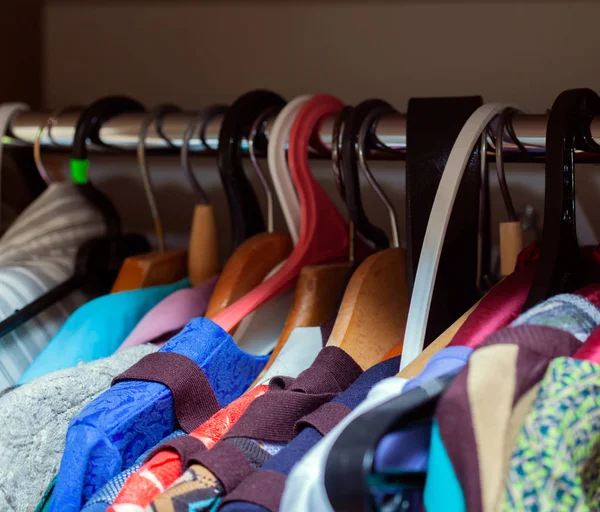 Вішаки з різним одягом в шафі — стокове фото
