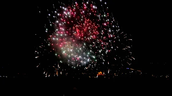 Firework above the city in the night sky — Stock Photo, Image