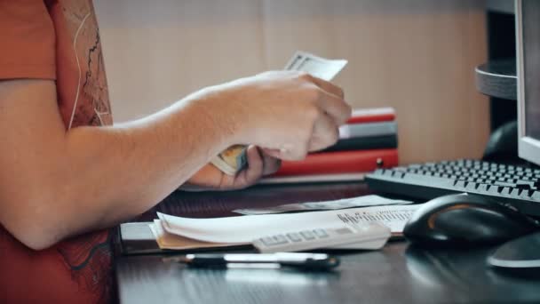 Man counting money and filling tax form — Stock Video