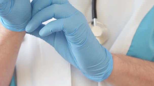 Doctor Putting Blue Latex Gloves Closeup — Stock Video