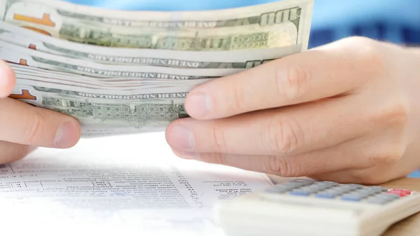 Man Counting Dollars Filling Tax Form Calculating Expenses Writing Tax — Stock Photo, Image