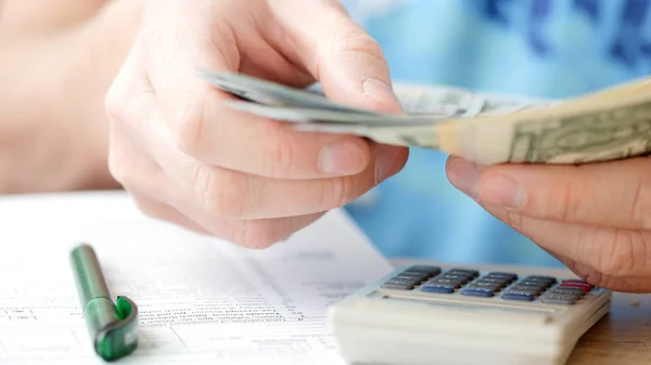 Man Counting Dollars Filling Tax Form Calculating Expenses Writing Tax — Stock Photo, Image