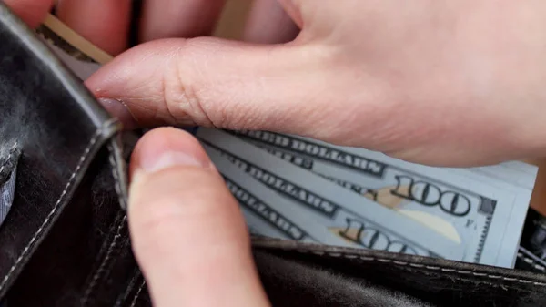 Money in the wallet. A man counting cash close-up