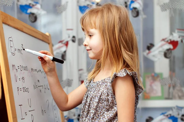 Smart girl near white board — Stock Photo, Image