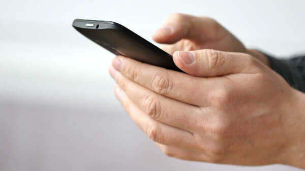 A man using apps on a mobile touchscreen smartphone