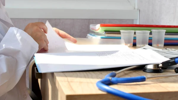 Doctor reading medical documents for medical research