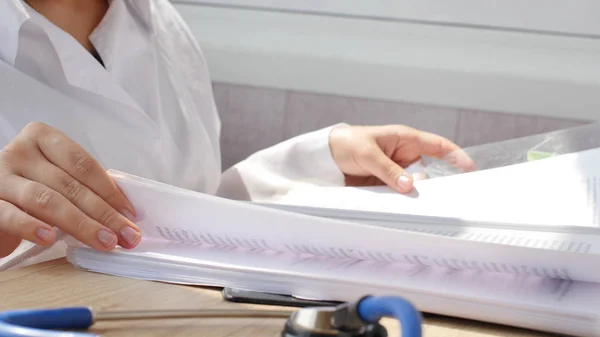 Doctor reading medical documents for medical research