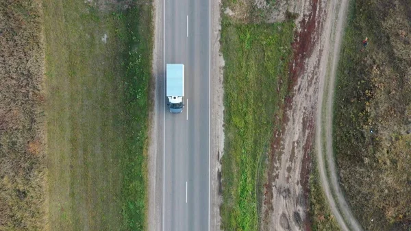 Aerial view of cars driving on country autumn road