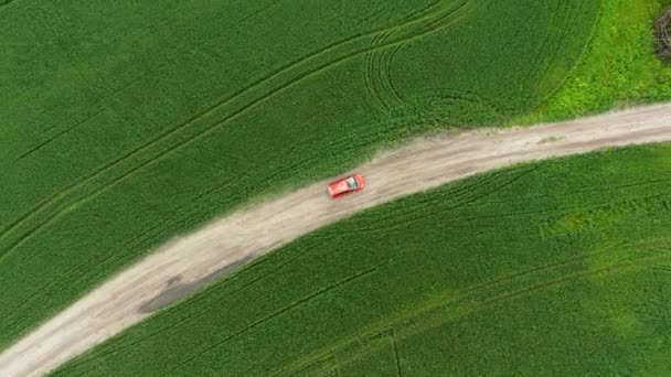 Aerial view of a red car driving on rural road — Stock Video