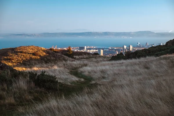 Scotland, Edinburgh - October 2018. The path among the hills, leaving the distance to the city and the sea.