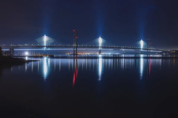 Night view of two bridges over the sea bay