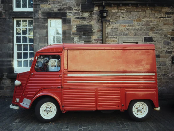 Red old car Citroen-Typ-H in front of the wall of an old castle