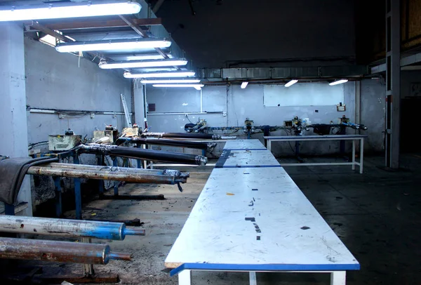 Photo of the deserted and traditional workshop of sewing and dyeing clothes and jeans with roses on the wall