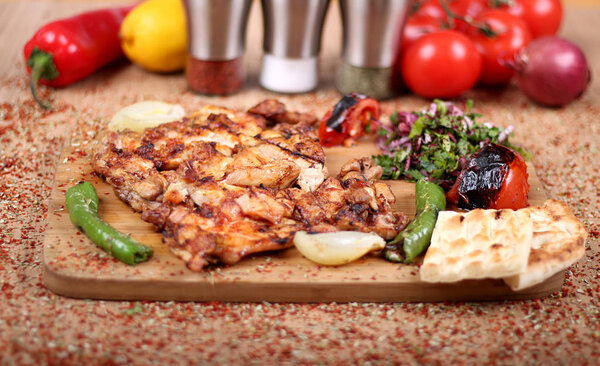 Grilled Chicken Serving on White Plate with Fresh Pepper  on Spi