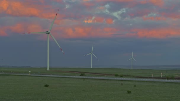 Autobahn und Windkraftanlage von oben, schöner Sonnenuntergangshimmel — Stockvideo