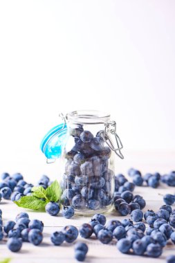 Beyaz ahşap zemin üzerinde cam nane ile taze yaban mersini yakından görmek