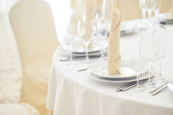 Close-up view of table in restaurant. Classic white interior of restaurant.