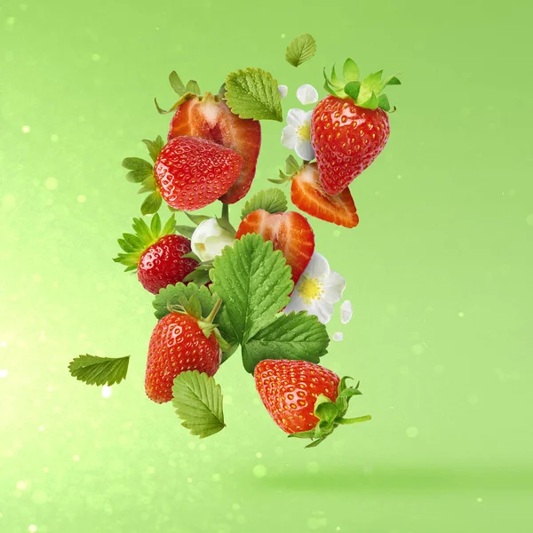 Flying Fresh tasty ripe strawberry with green leaves at light green background.  Food levitation concept. Creative food layout, High resolution image