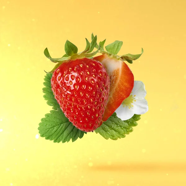 Flying Fresh tasty ripe strawberry with green leaves at light yellow background.  Food levitation concept. Creative food layout, High resolution image