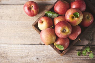 Ahşap masa üzerinde taze sulu olgun kırmızı elma