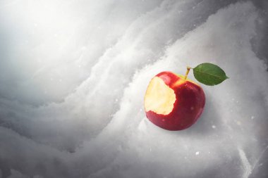 Fairy tale tale concept with poisoned bitten red apple laying on marble, sunlight and defocused falling snow, top view, high quality image. Once upon a time. clipart