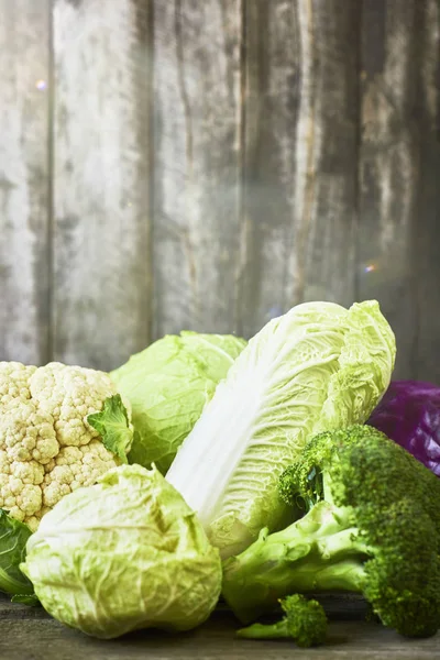 Many sorts of cabbage on rustic wooden background — Stock Image Many Sorts Cabbage Rustic Wooden Background Stock Picture
