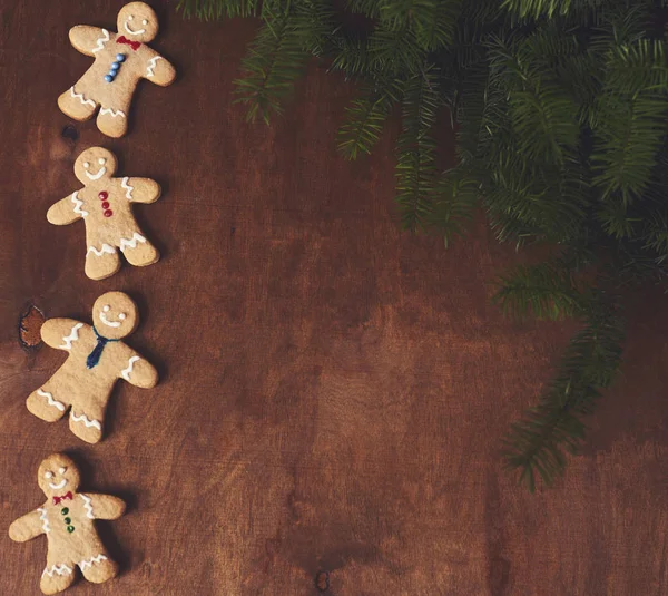 Christmas gingerbread man with christmas tree on wooden board.