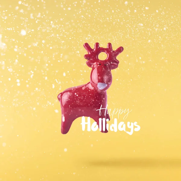 圣诞节的概念 创意圣诞构想由落在空气红色圣诞鹿玩具在黄色背景 最小的概念 — 图库照片