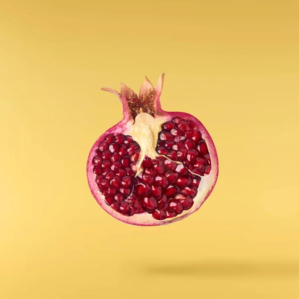Flying Air Fresh Ripe Pomegranate Isolated Yellow Background High Resolution — Stock Photo, Image